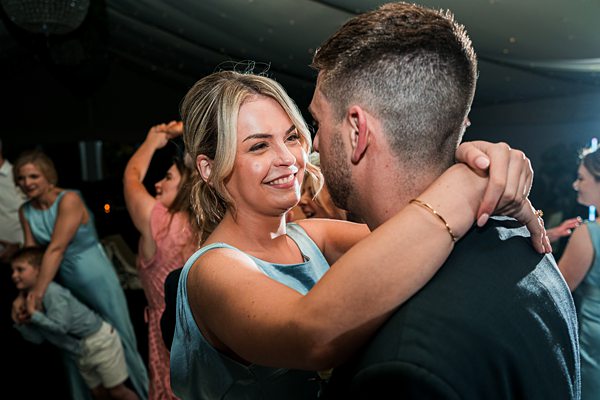 Couple dancing at festive event.