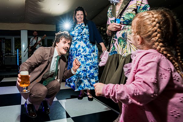 People enjoying a lively wedding reception dance floor.