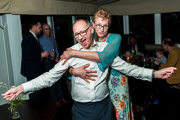 Couple joyfully dancing at a party.