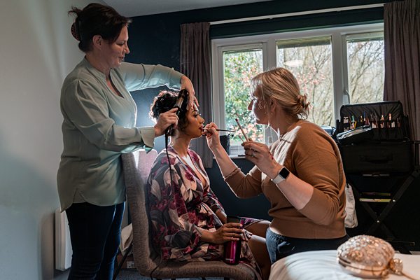 Bridal makeup and hairstyling session in progress.