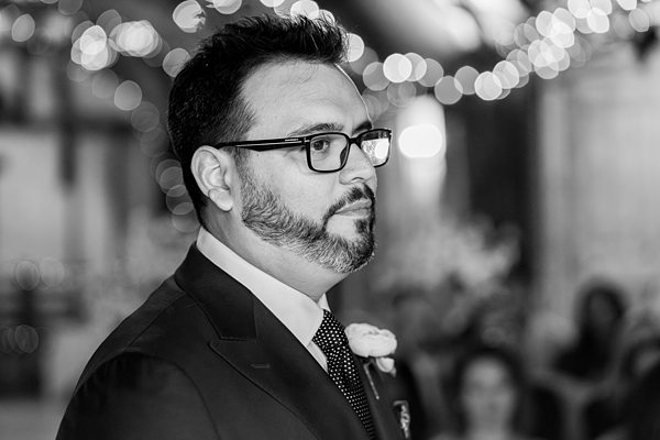 Man in suit at event, black and white photo