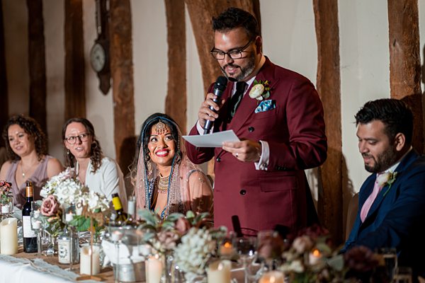 Groom giving speech at wedding reception.