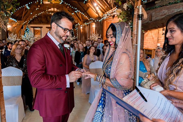 Couple exchanging rings at wedding ceremony.