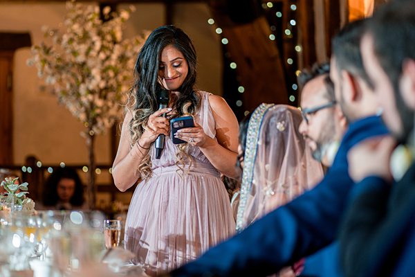 Woman reading speech at wedding reception.