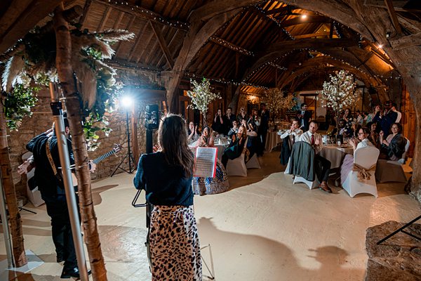 Wedding speech in rustic barn venue.
