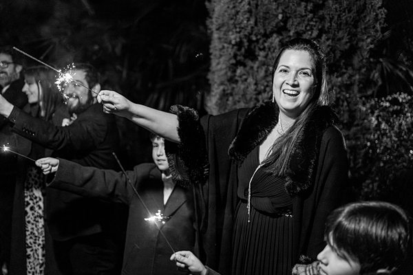 Guests enjoying sparklers at evening celebration.