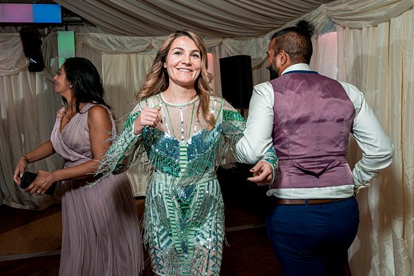 Guests dancing at festive party event.