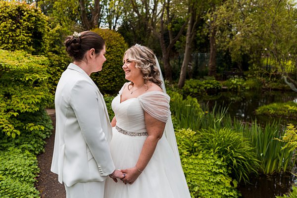 Bride and partner at garden wedding ceremony.