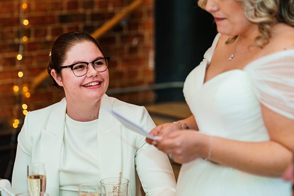 Two women smiling at celebratory event.