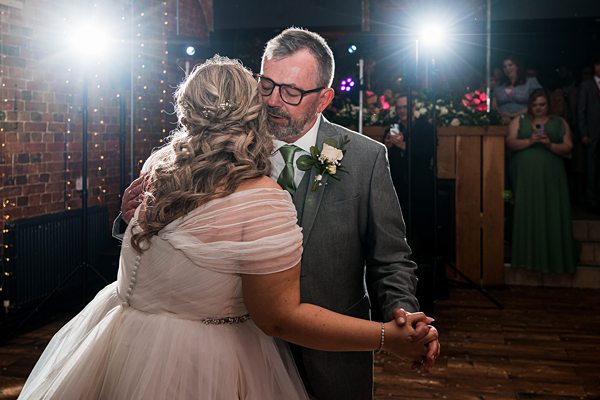 Bride and father dance at wedding reception.