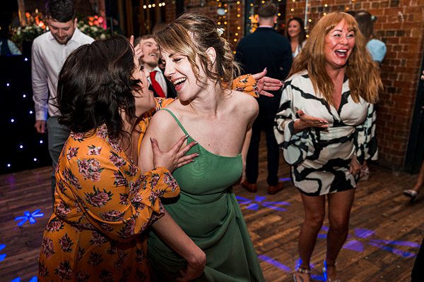 Joyful people dancing at a festive event.