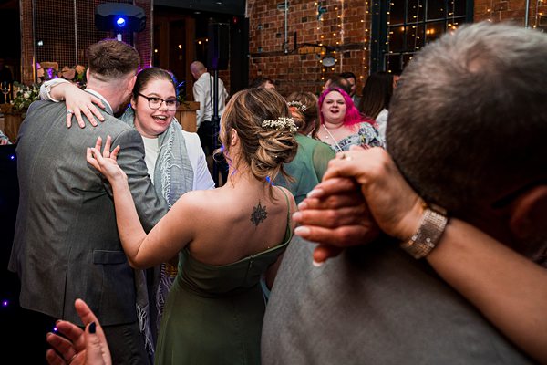 People dancing at an indoor celebration.