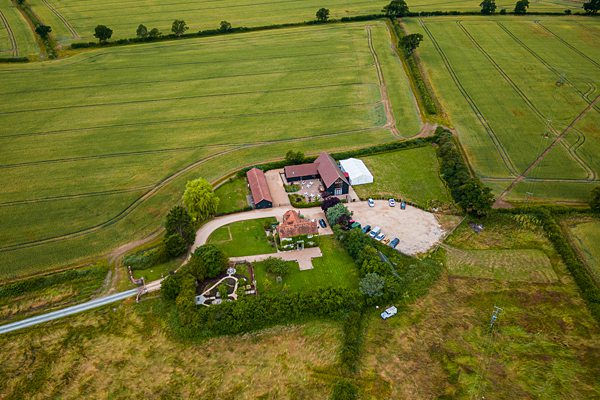 Aerial view of a rural farmstead with fields.