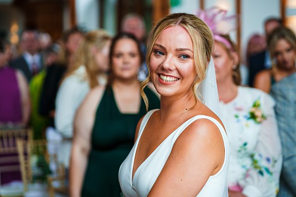 Bride smiling at wedding ceremony.