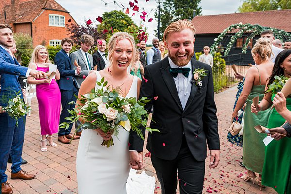 Bride and groom smiling during wedding ceremony.
