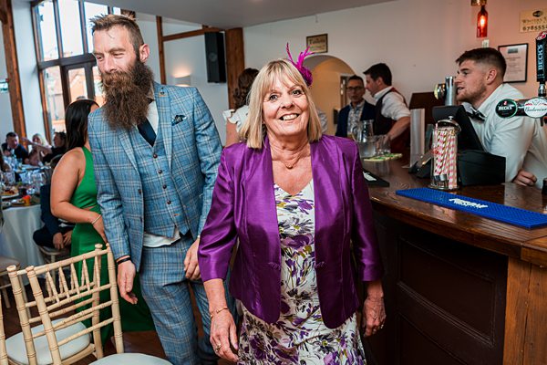 Guests smiling at festive event in pub.