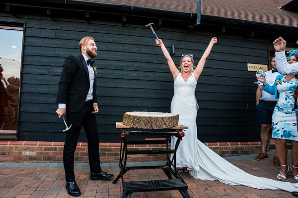 Joyful wedding log cutting ceremony.