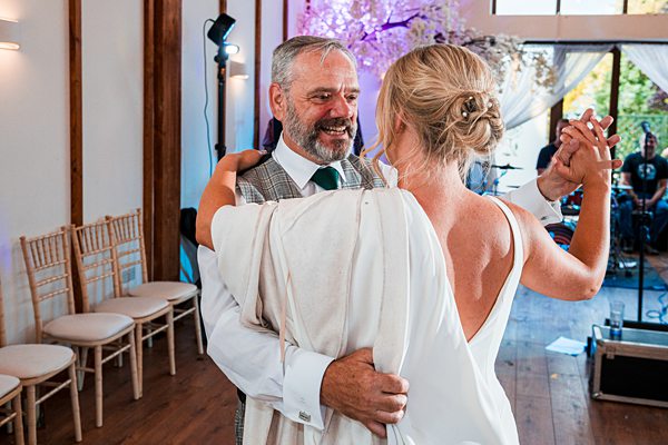 Bride dancing with father at wedding reception.