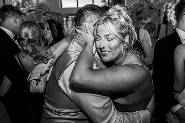 Emotional black and white wedding hug