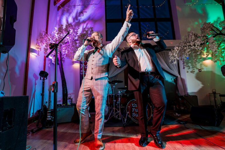 Two singers performing live at an event.