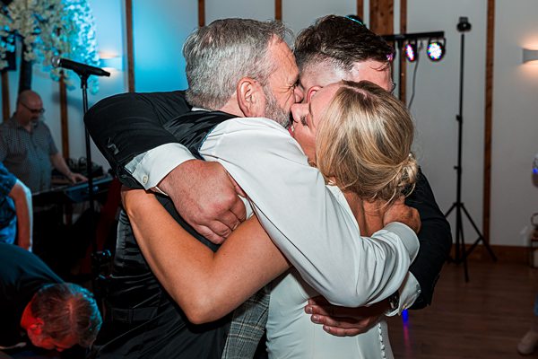 Family members embracing at celebration.