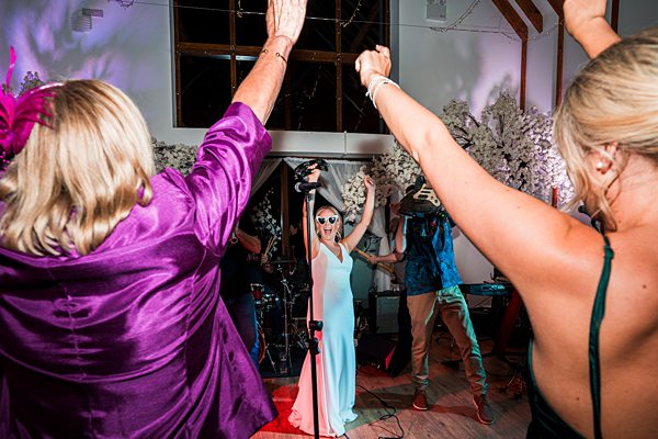 Guests dancing at indoor celebration.