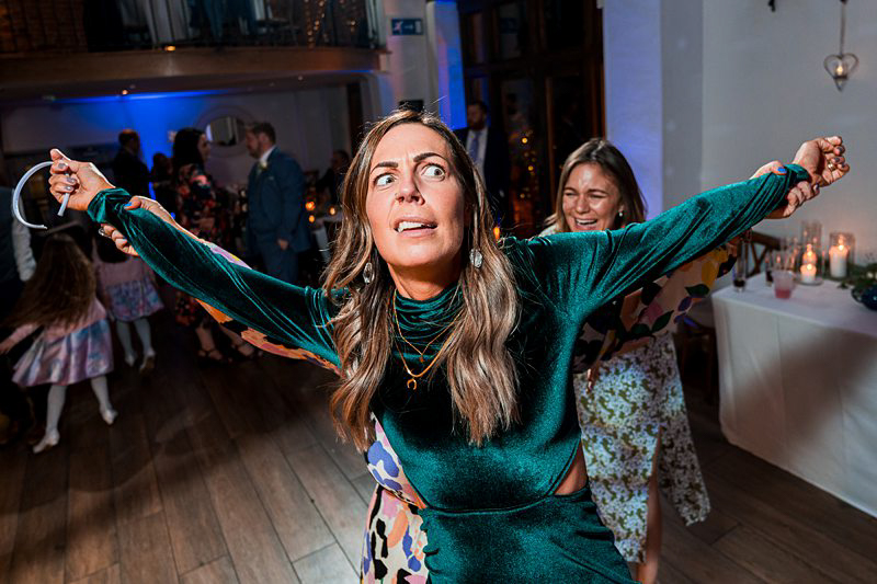 Woman dancing at a party with dramatic expression.