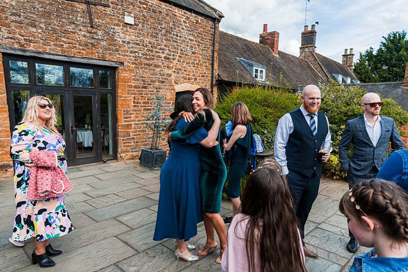 Guests socializing at a courtyard event.