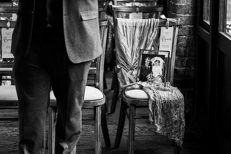 Reserved chair with wedding photo at event.