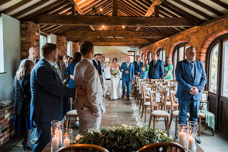 Wedding ceremony in rustic barn venue.