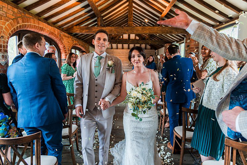 Bride and groom walking down the aisle after ceremony.