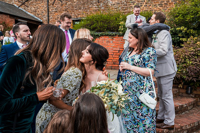 Wedding guests mingling outside.