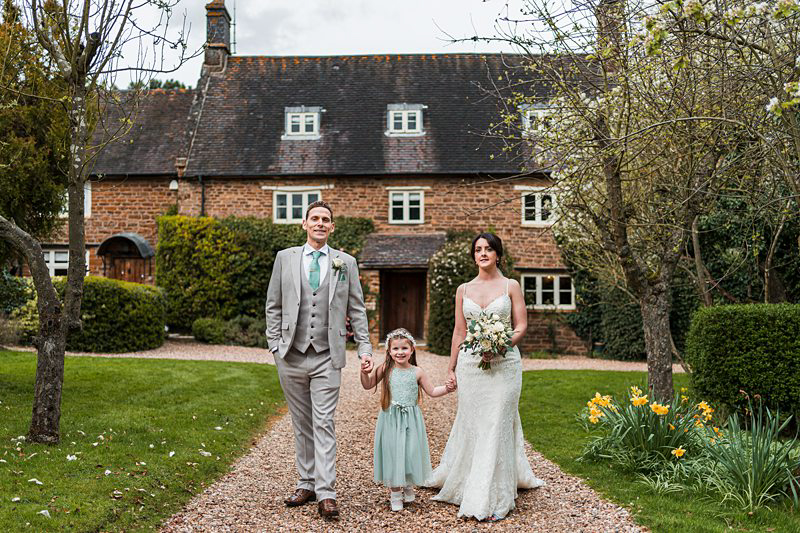 Wedding family outside quaint country house.