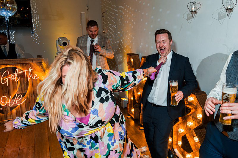 People dancing at joyful indoor party.