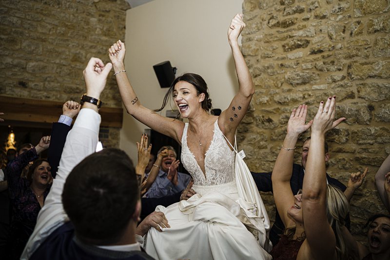 Bride's chair lift celebration at wedding reception.