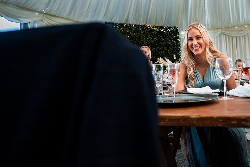 Woman smiling at festive event table.