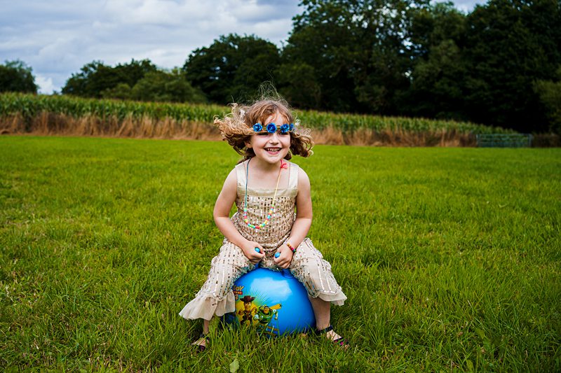 Girl playing with ball in field.
