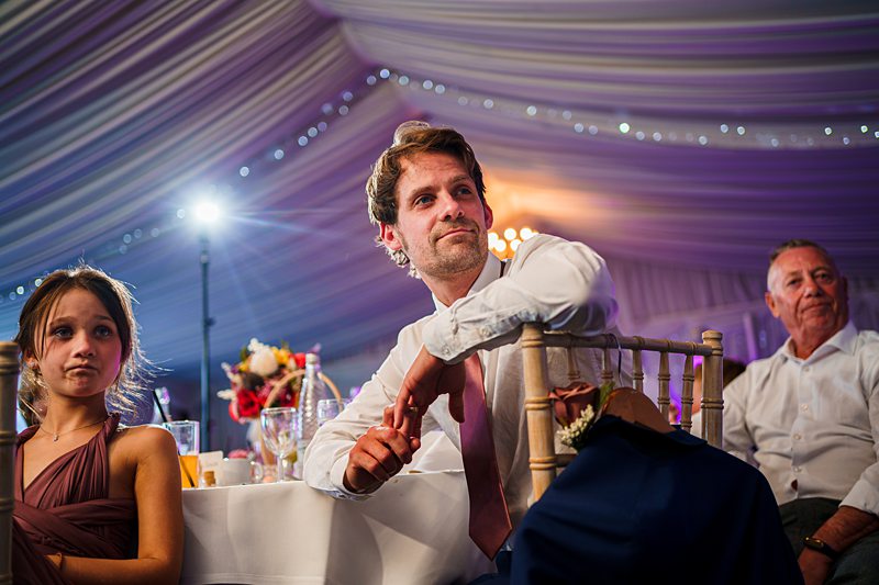 Guests seated at elegant wedding reception.