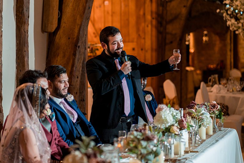 Best man giving speech at wedding reception.