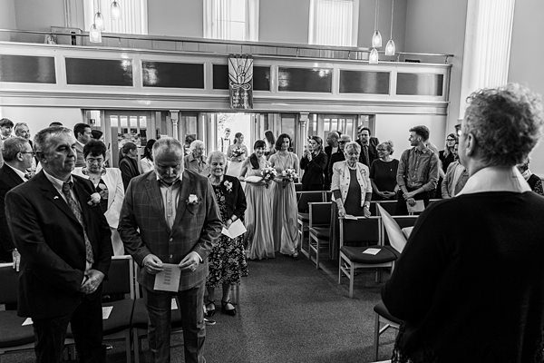 Wedding ceremony in a church, guests standing.