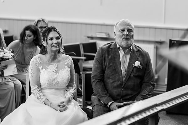 Bride and groom smiling during wedding ceremony