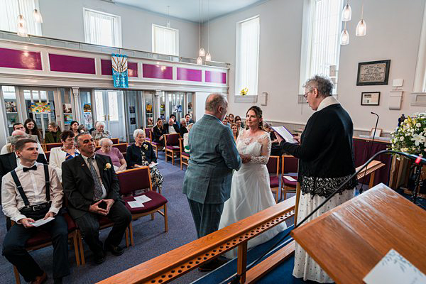 Wedding ceremony in progress at a vibrant venue.