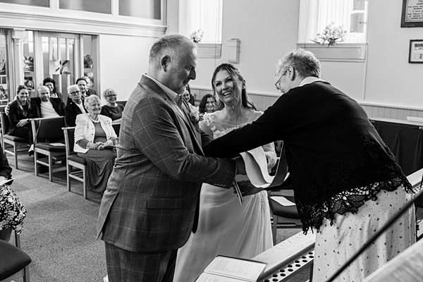 Wedding ceremony exchange of rings moment.