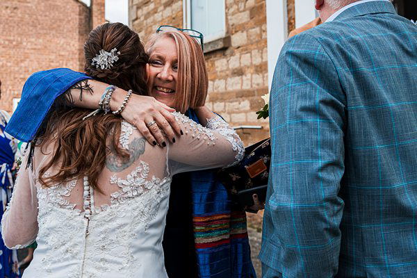 Women embracing at a wedding celebration.