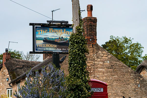 Traditional British pub sign and red phone box.
