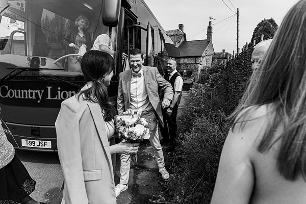 Bride and groom alighting from wedding shuttle bus.