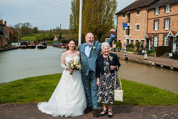 Wedding celebration by canal with family, rural UK setting.