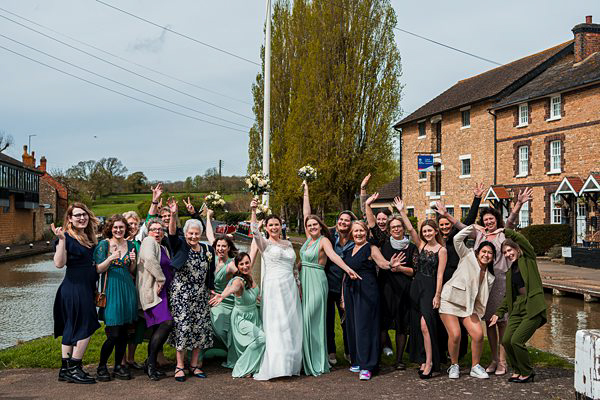 Group celebrating at a wedding by the canal.