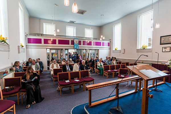Interior of modern church with congregation during service.