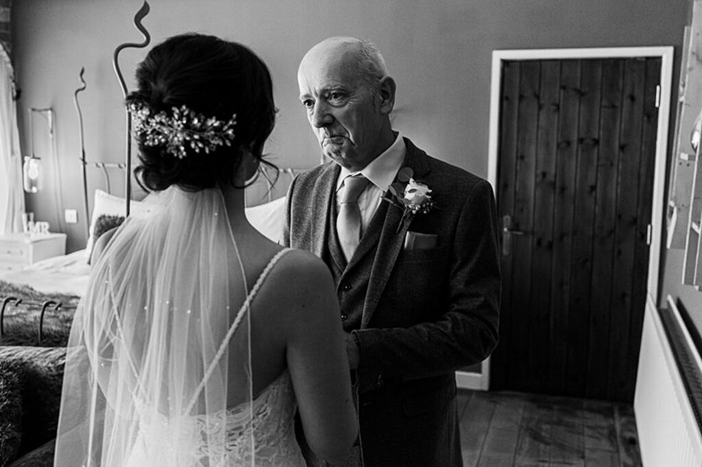 Father and bride share emotional moment before wedding.